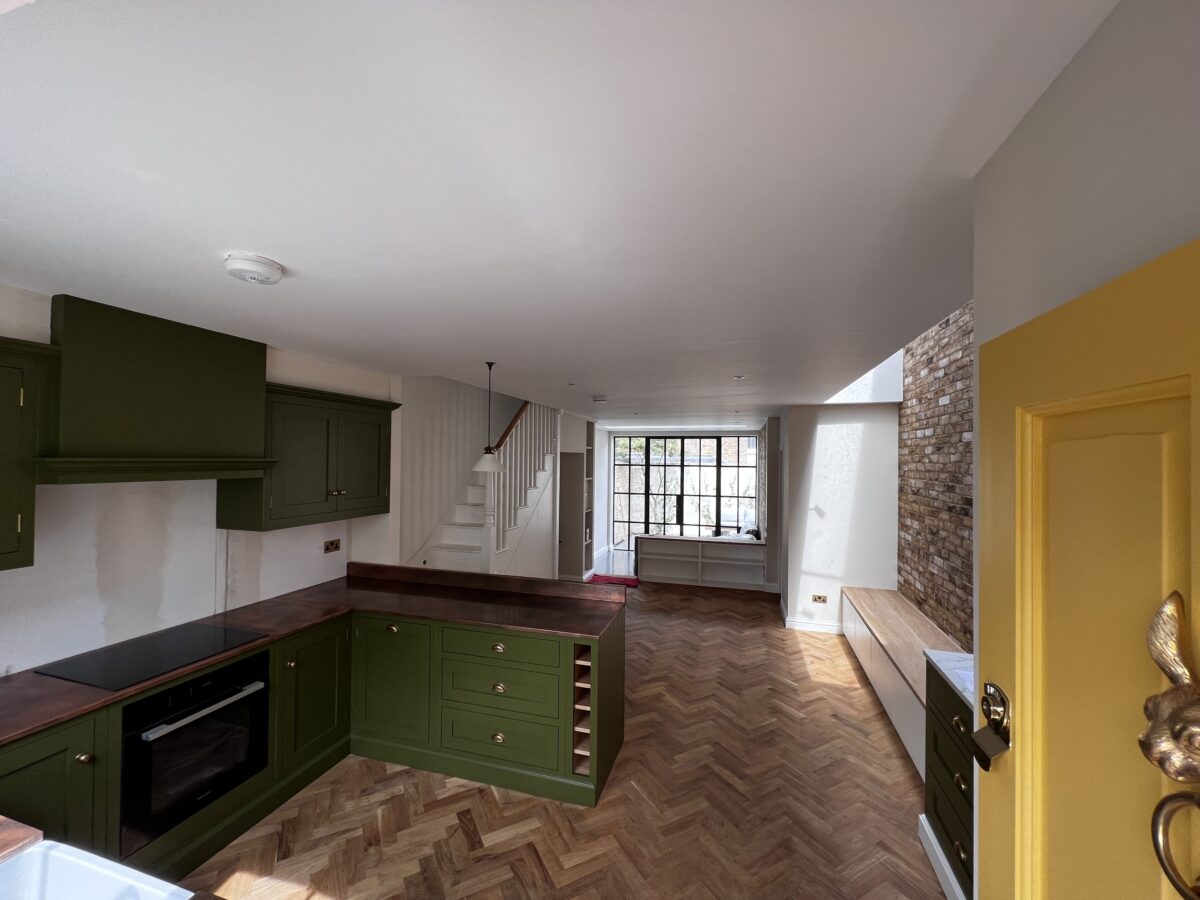 Renovated ground floor with green shaker kitchen and herringbone parquet floor in a Richmond terraced house