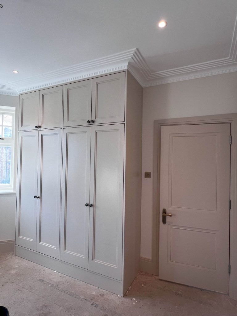 Tall fitted wardrobes with panelled doors