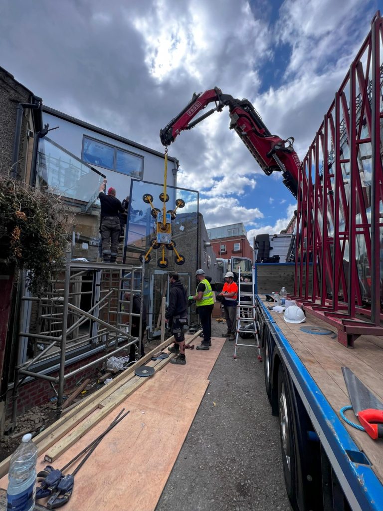 Glazing units lifted by crane onto a building site