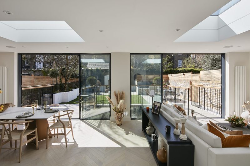 Open-plan kitchen and dining room with rooflights and sliding doors