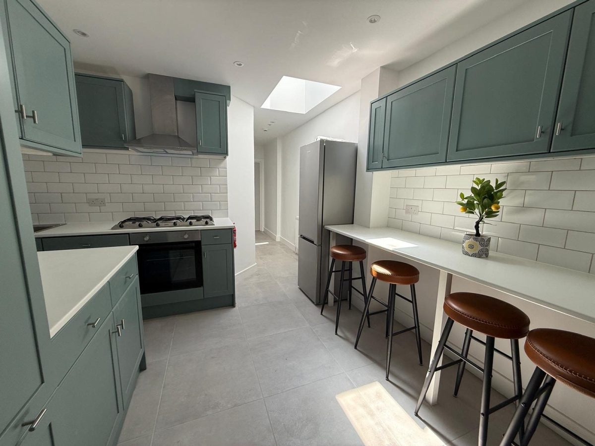 Shaker-style kitchen with rooflight and breakfast bar