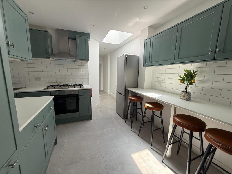 Shaker-style kitchen with rooflight and breakfast bar