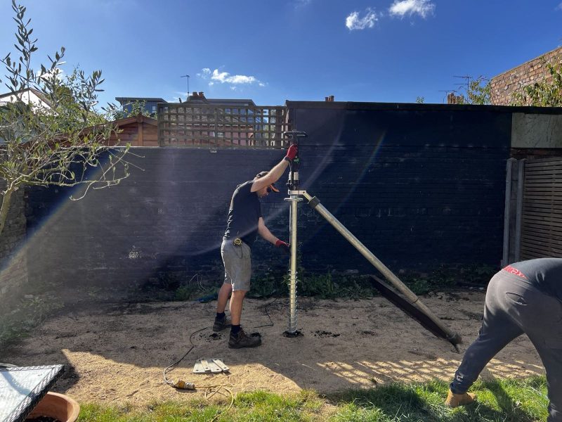 Ground-screw foundations being installed for a garden office in Surbiton