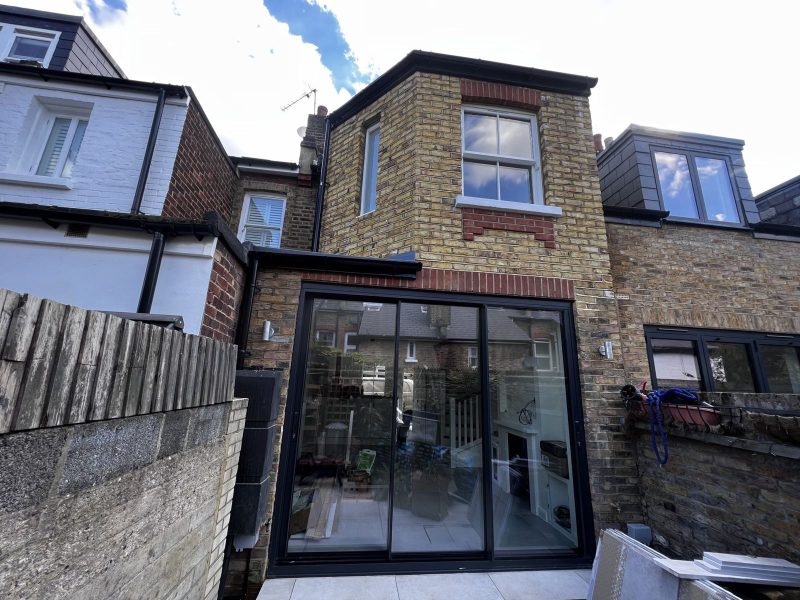Brick rear extension with black-framed sliding doors in Richmond