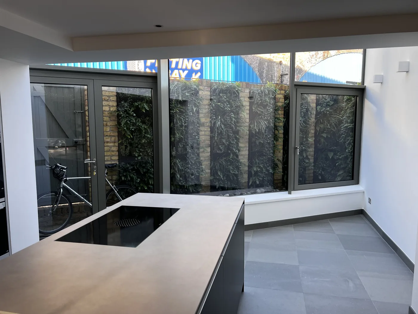 Kitchen island with large aluminium-framed glazing and doors, Florian Road, Putney