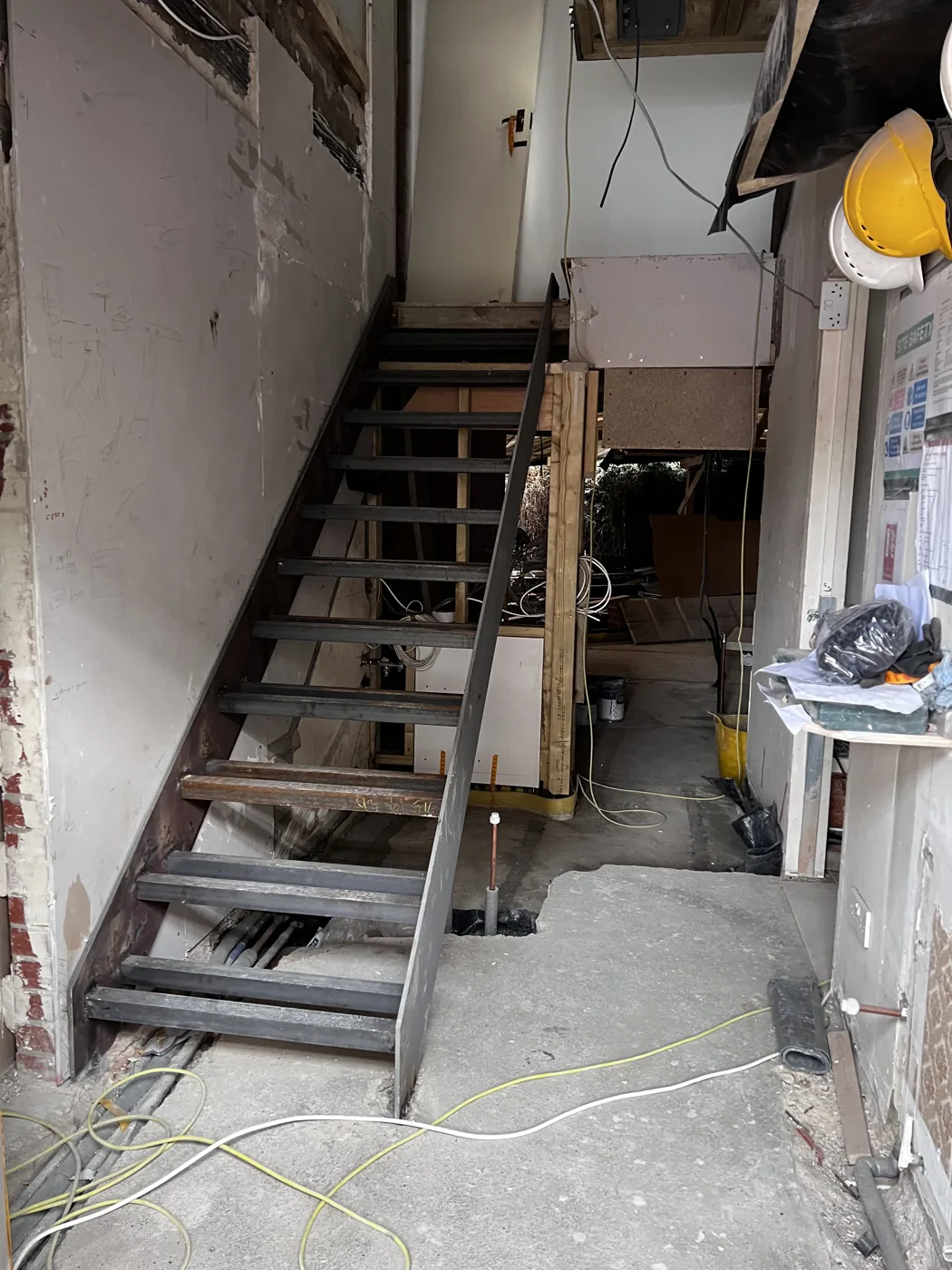 Building work in progress with a temporary steel stair and exposed structure, Florian Road, Putney