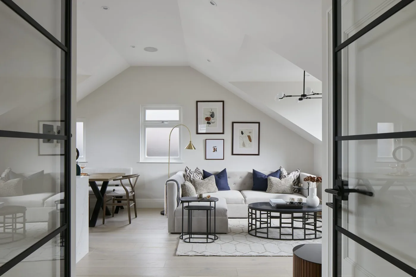 Loft living room with a vaulted ceiling and steel-framed glazed doors