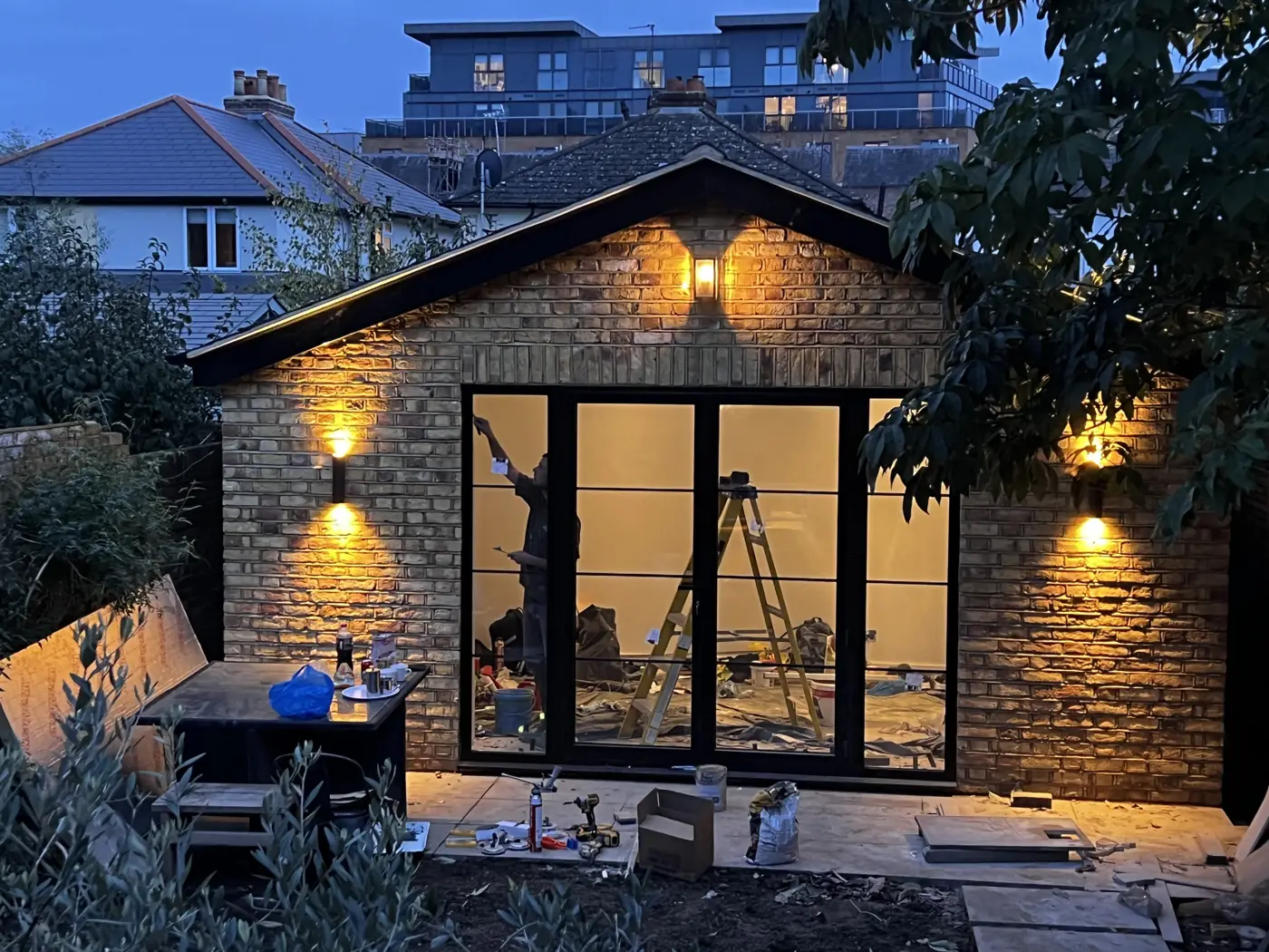 Garden office with wall lights on at dusk, Maple Road, Surbiton