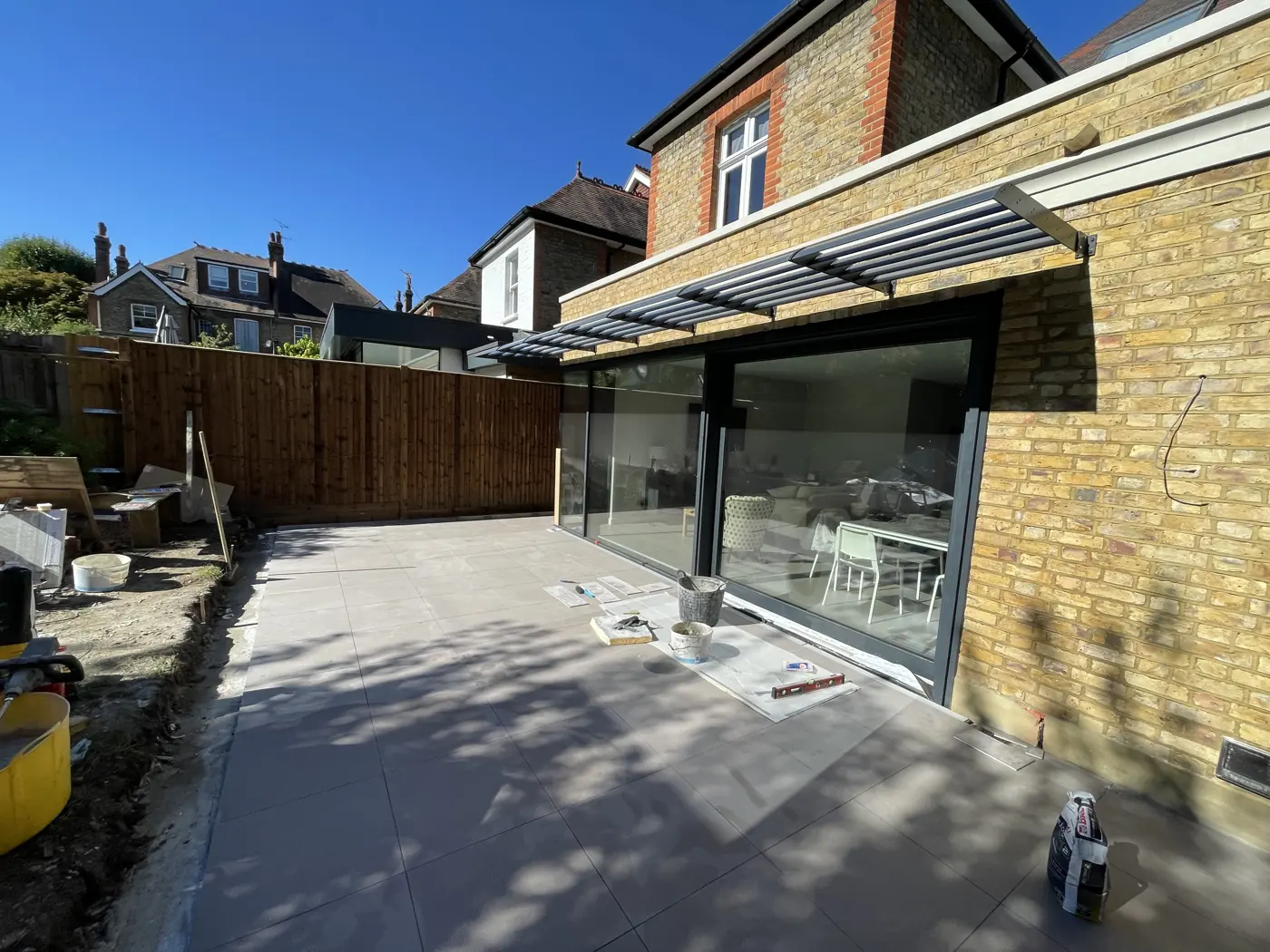 Rear extension with glazing installed and the terrace being finished, Montolieu Gardens, Putney